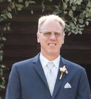 Acolyte Steve Chickering in a navy suit