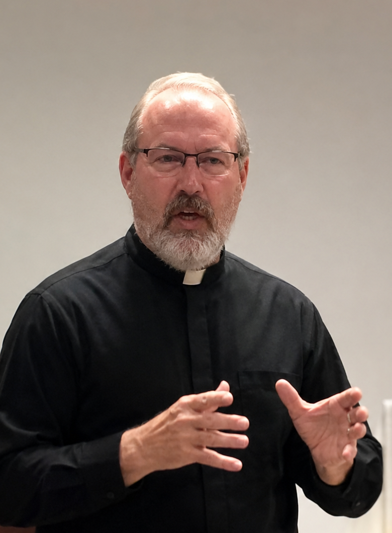 Deacon Doug Culver in a black clerical shirt and Roman collar