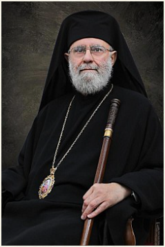 His Eminence Metropolitan Saba in monastic klobuk, holding a pastoral staff