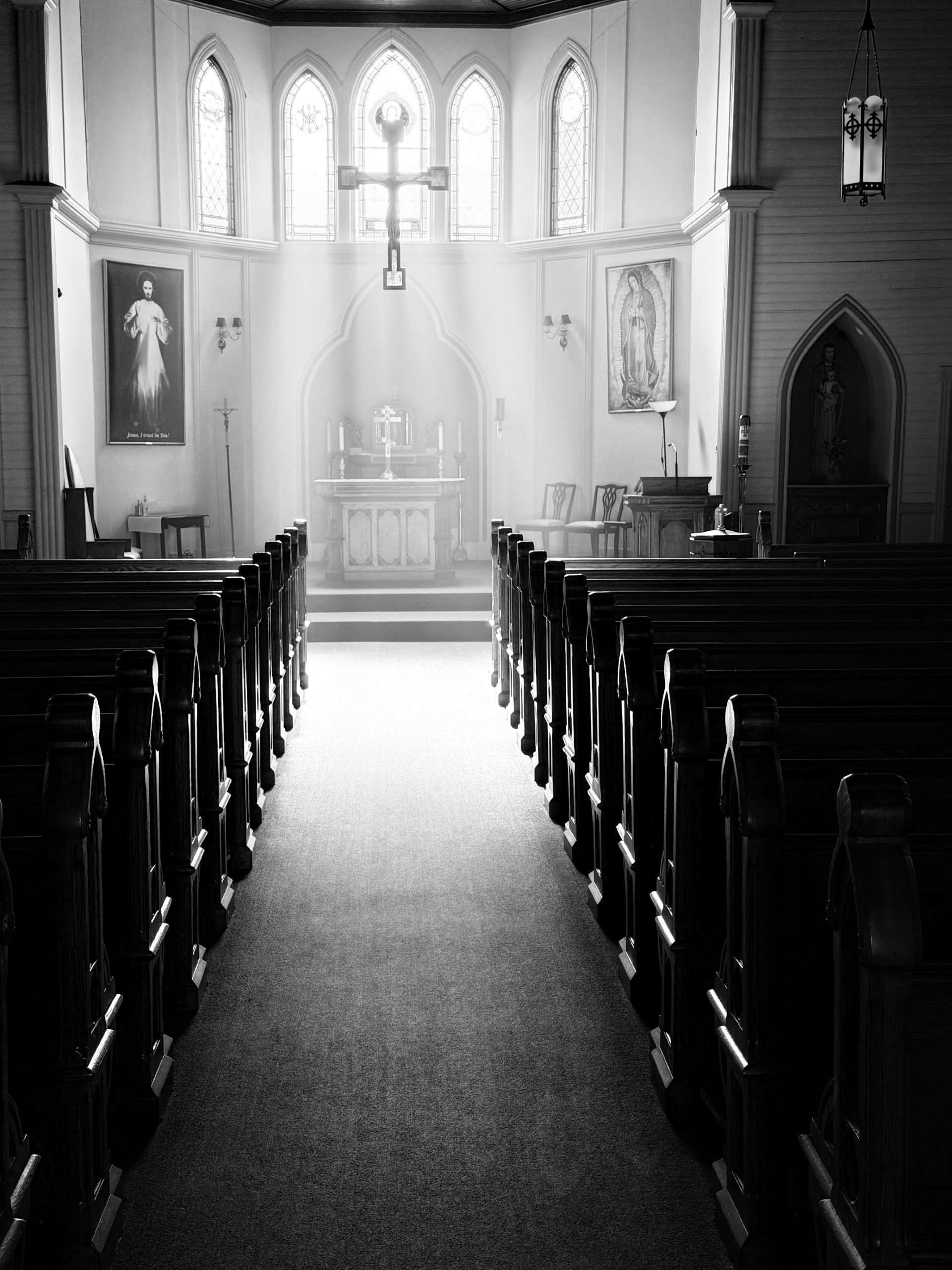 The nave of Emmanuel Orthodox Church looking toward the altar, crucifix, and stained glass windows