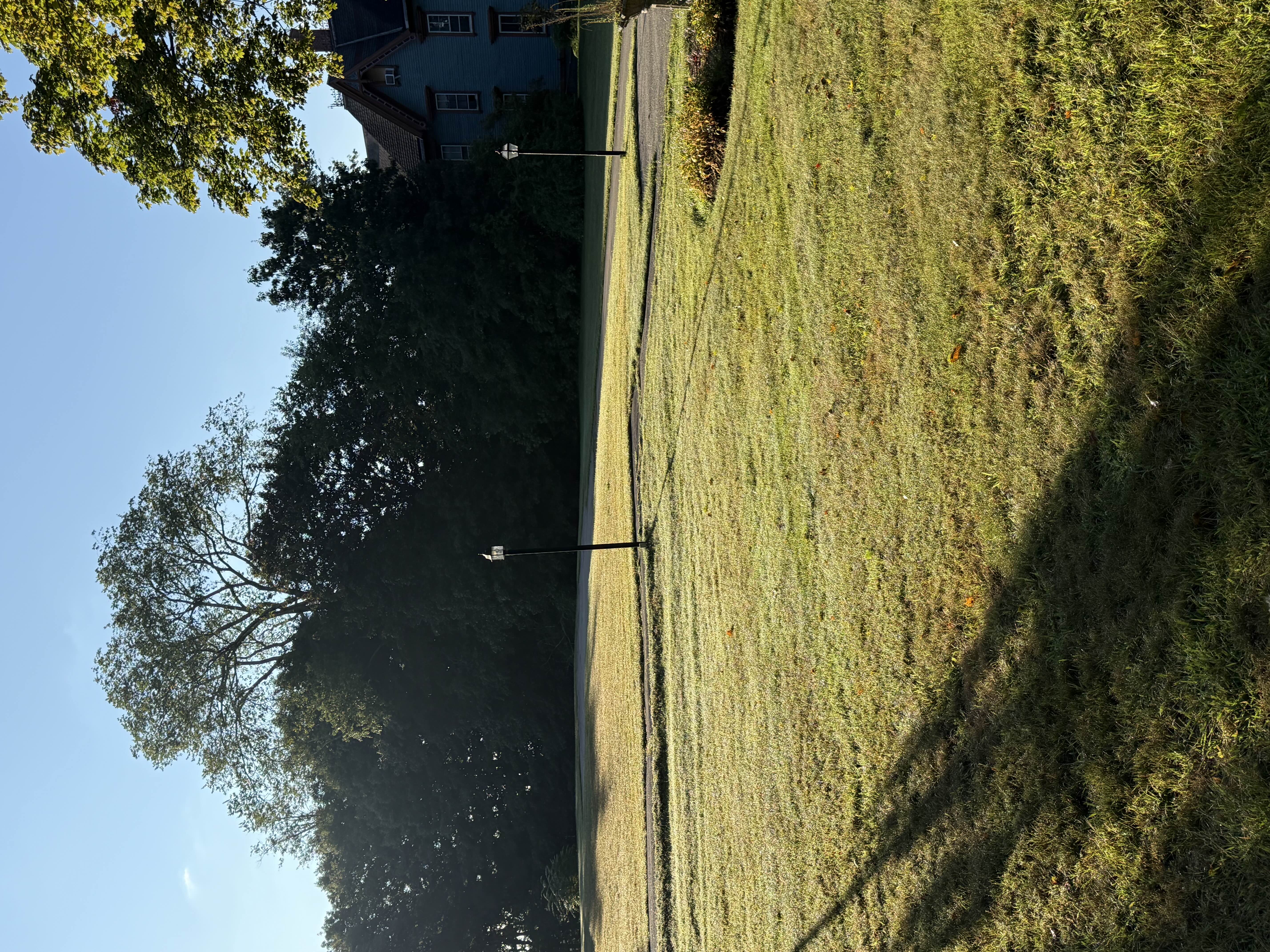Open church lawn with lamp posts in the early morning sun