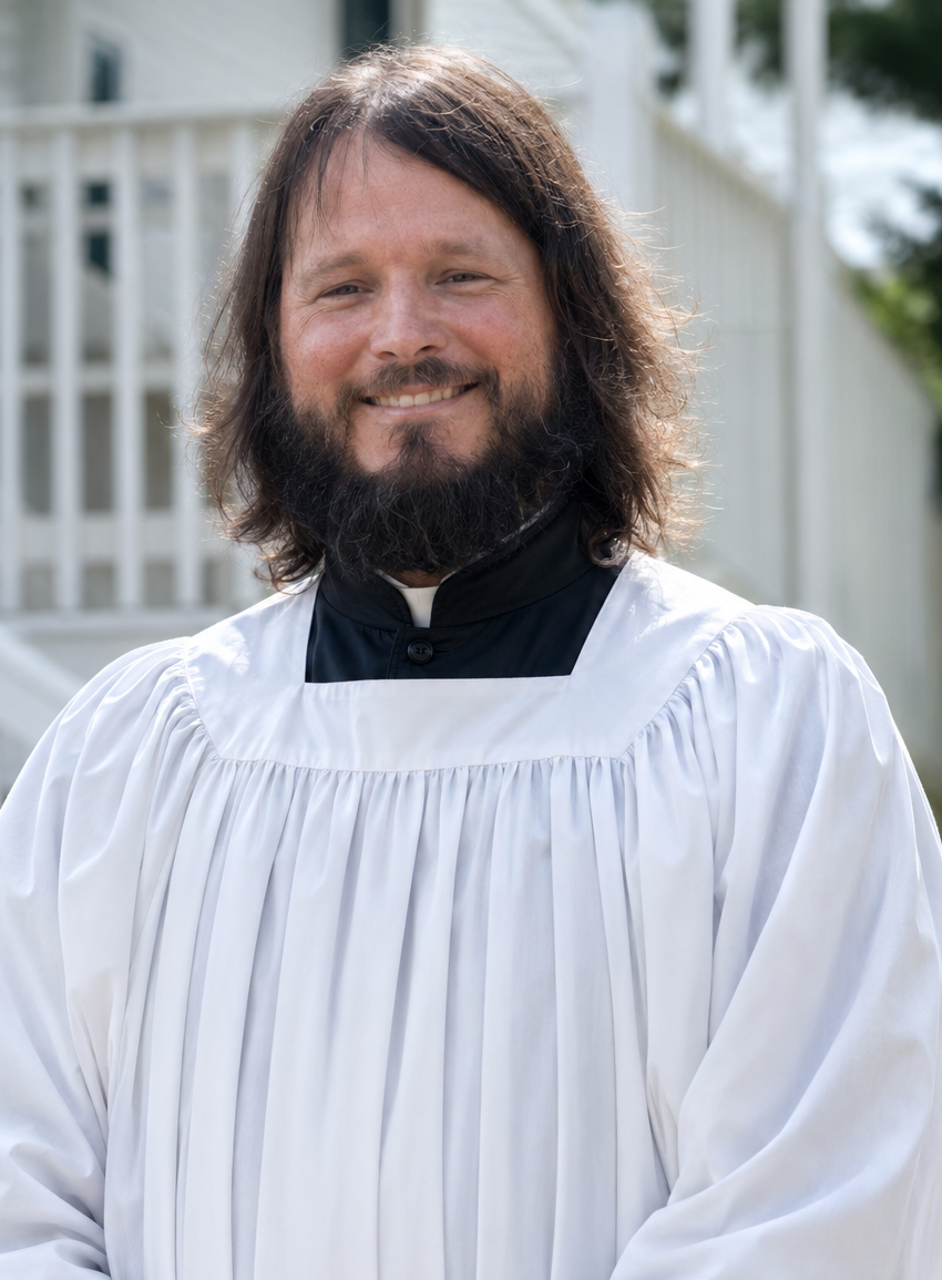 Subdeacon Anthony Neigel in a black cassock and white surplice