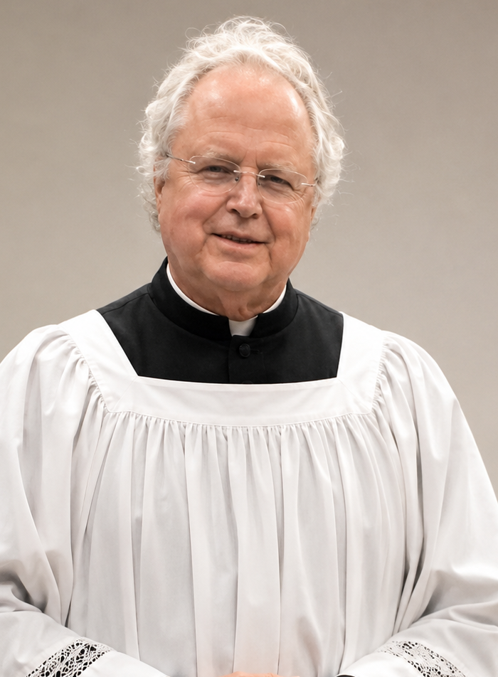 Subdeacon William Tasker in a black cassock and white lace-trimmed surplice